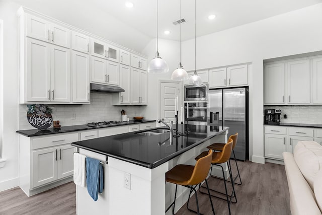 kitchen featuring dark countertops, appliances with stainless steel finishes, and a sink