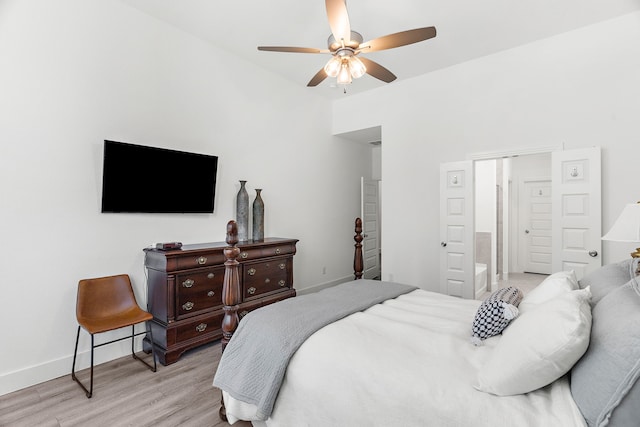 bedroom with light wood-type flooring, a ceiling fan, and baseboards