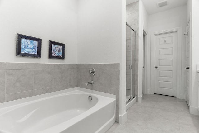 bathroom with a bath, visible vents, and a stall shower
