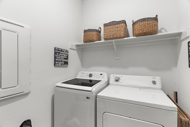 washroom with washing machine and clothes dryer and laundry area