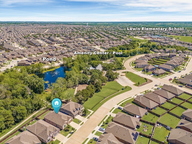 drone / aerial view featuring a residential view and a water view