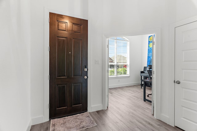foyer featuring light wood-type flooring and baseboards