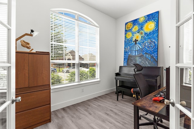 sitting room featuring baseboards and light wood-type flooring