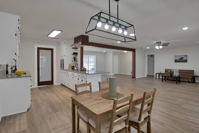 dining space with a ceiling fan, baseboards, recessed lighting, and light wood-type flooring