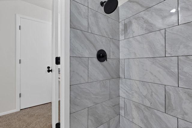 interior details with carpet flooring and a tile shower