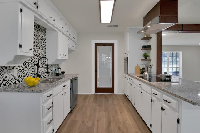 kitchen featuring open shelves, wall chimney exhaust hood, a peninsula, visible vents, and black appliances