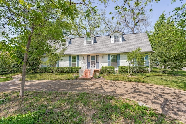 cape cod home with a front yard