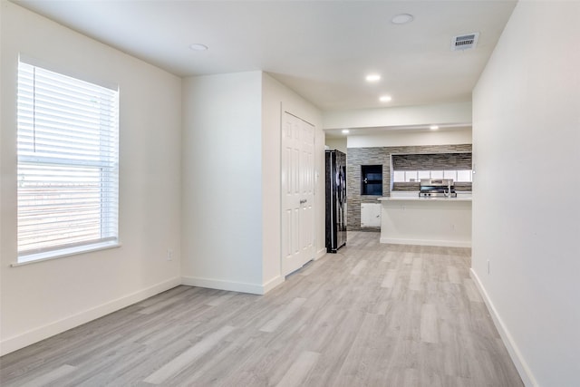 interior space with baseboards, visible vents, recessed lighting, and light wood-style floors