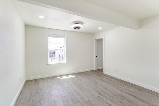 empty room featuring recessed lighting, wood finished floors, and baseboards