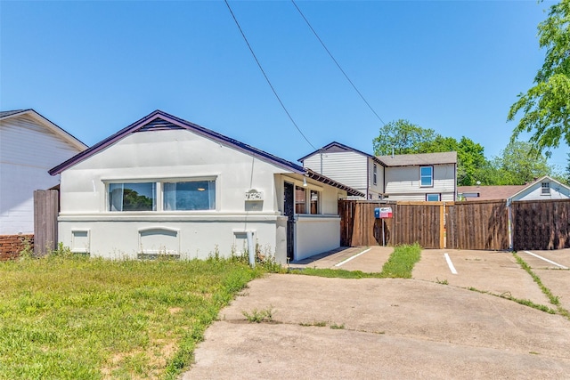 view of front facade featuring fence private yard and stucco siding