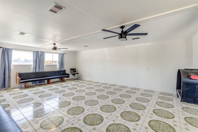 living room featuring baseboards, a ceiling fan, and visible vents