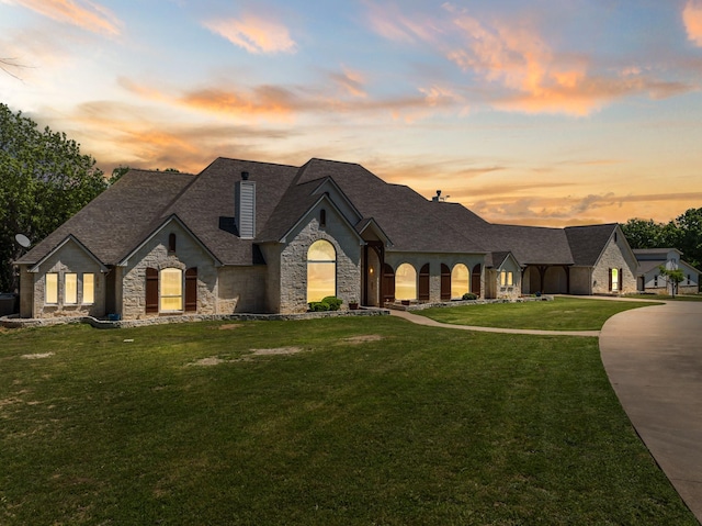 6263 Fm 934, Milford, TX 76670 - french country inspired facade featuring a lawn, a chimney, stone siding, and a shingled roof