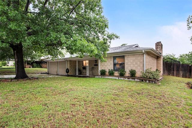 ranch-style house featuring a garage, fence, a front yard, a chimney, and brick siding