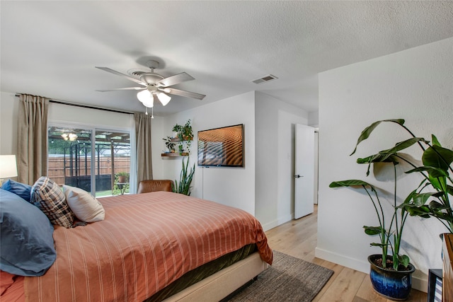 bedroom featuring visible vents, a ceiling fan, light wood-style flooring, and baseboards