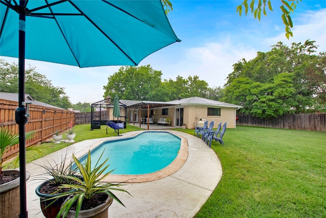 view of pool featuring a fenced backyard, a fenced in pool, a yard, and a patio area