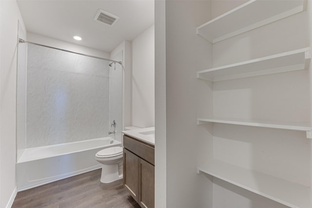 bathroom featuring wood finished floors, visible vents, toilet, vanity, and shower / tub combination