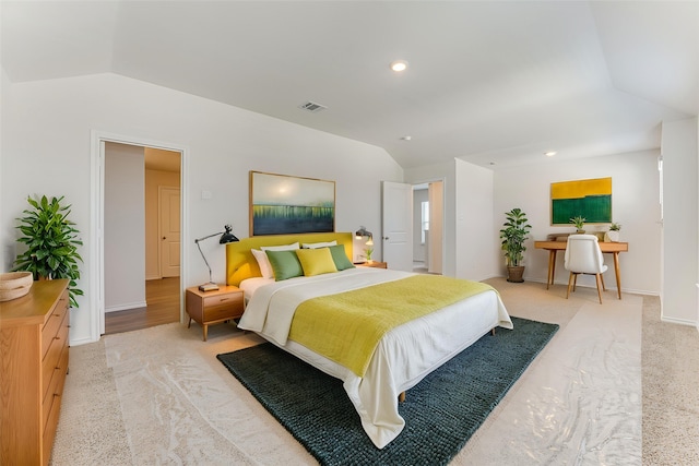 bedroom with vaulted ceiling, carpet flooring, visible vents, and baseboards