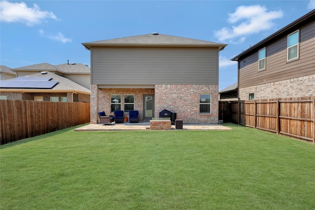 rear view of property with a fenced backyard, a yard, and a patio area