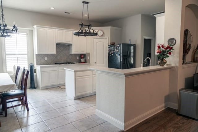 436 Dakota Dr, Murphy, TX 75094 - kitchen featuring a chandelier, black fridge, tasteful backsplash, light countertops, and recessed lighting