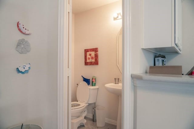 436 Dakota Dr, Murphy, TX 75094 - half bathroom with toilet, tile patterned floors, and baseboards