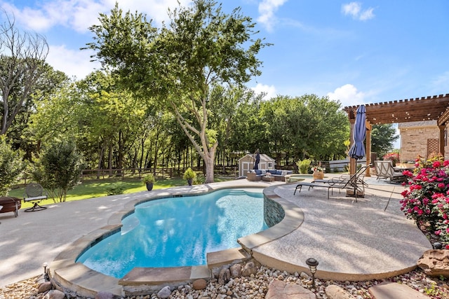 pool featuring a pergola, a patio area, a fenced backyard, an outbuilding, and a storage unit