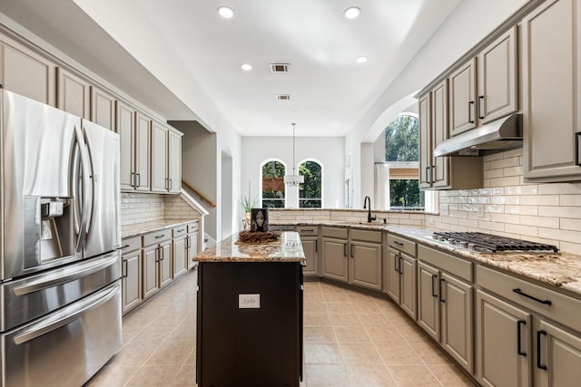 kitchen with visible vents, recessed lighting, under cabinet range hood, a kitchen island, and appliances with stainless steel finishes