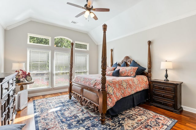 bedroom with a ceiling fan, wood finished floors, lofted ceiling, ornamental molding, and visible vents