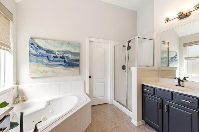 bathroom featuring a shower stall, vanity, tile patterned floors, and a jetted tub