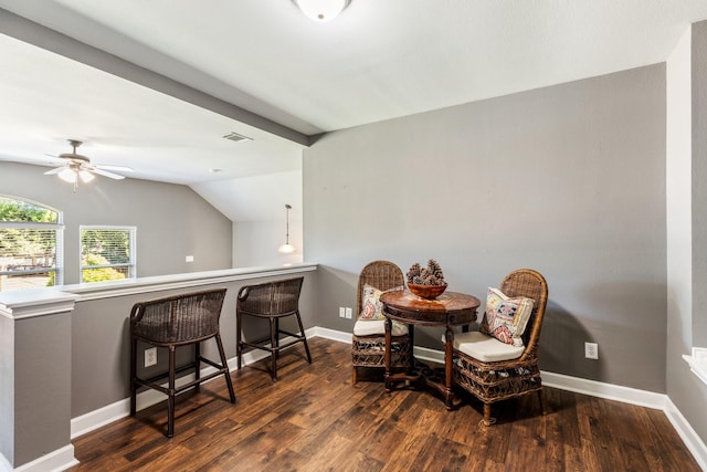 dining area featuring vaulted ceiling, wood finished floors, a ceiling fan, and baseboards