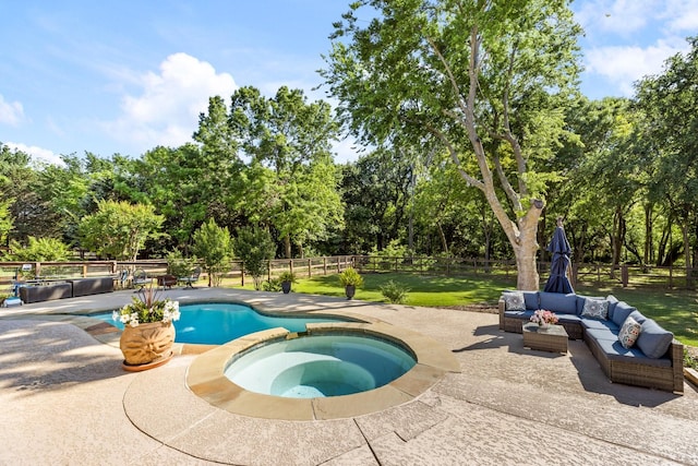 view of swimming pool featuring a fenced backyard, an outdoor hangout area, a yard, a pool with connected hot tub, and a patio