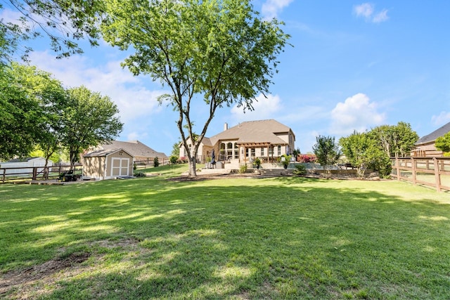 view of yard featuring a pergola, a fenced backyard, an outbuilding, and a storage shed