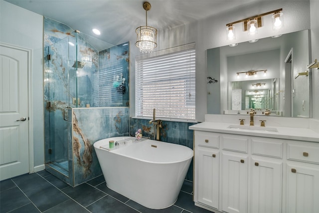 full bath featuring a freestanding bath, a shower stall, tile patterned floors, and vanity
