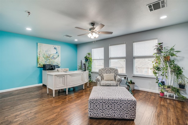 sitting room featuring dark wood finished floors, ceiling fan, baseboards, and visible vents
