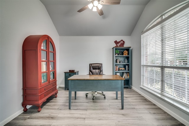 office area featuring light wood-style floors, lofted ceiling, a ceiling fan, and plenty of natural light