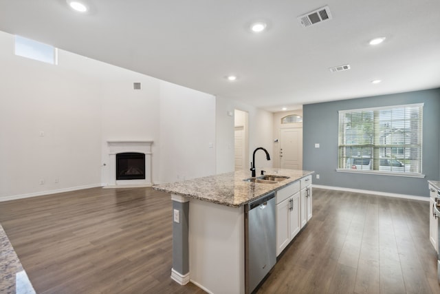 kitchen with a sink, white cabinets, stainless steel dishwasher, and visible vents