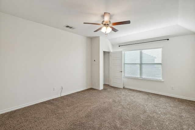 spare room with baseboards, carpet, a ceiling fan, and visible vents