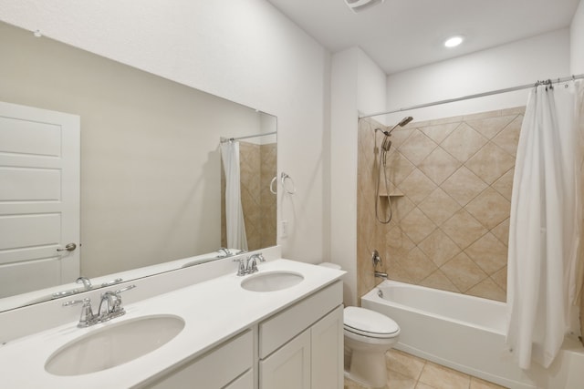 bathroom featuring toilet, tile patterned floors, a sink, and shower / tub combo with curtain