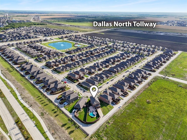 birds eye view of property with a residential view and a water view