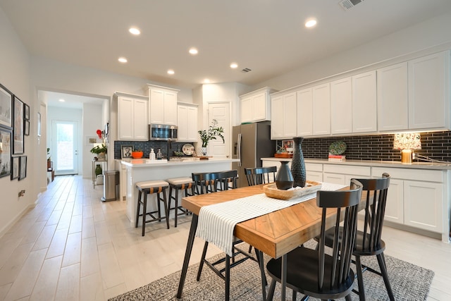 dining area with recessed lighting, visible vents, and light wood-type flooring
