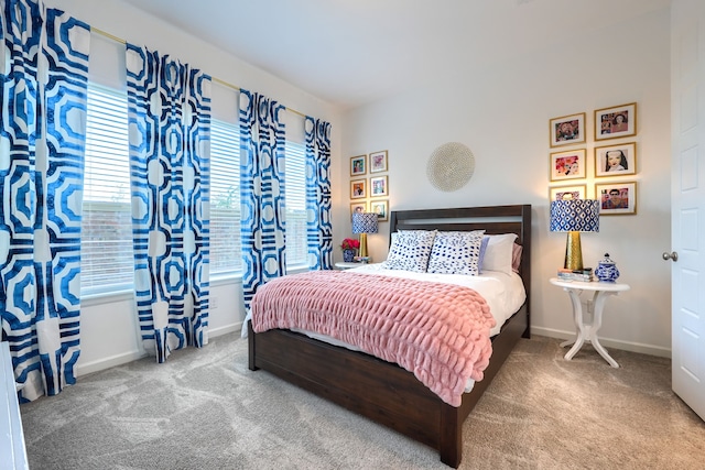 carpeted bedroom featuring baseboards