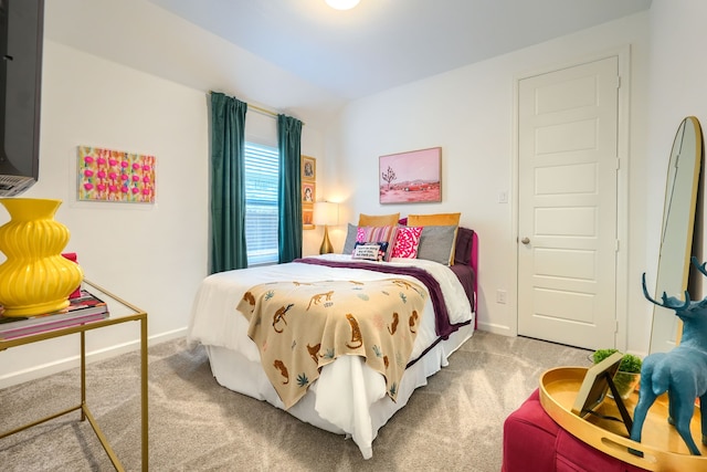 carpeted bedroom featuring baseboards