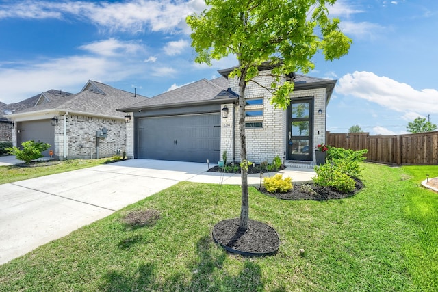 view of front of property featuring driveway, a front yard, a garage, brick siding, and fence