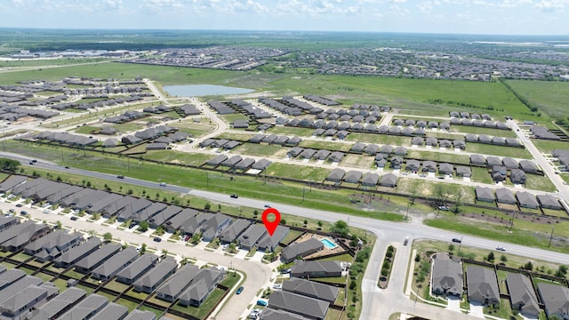 drone / aerial view featuring a water view and a residential view