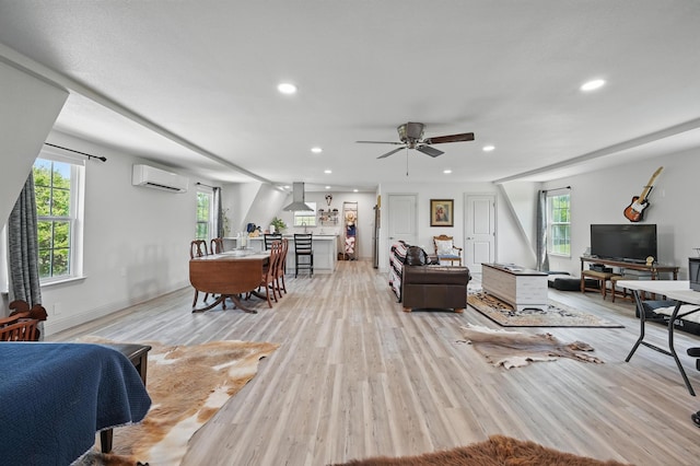 living area with light wood-type flooring, ceiling fan, recessed lighting, and a wall unit AC