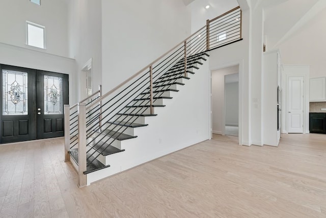 3737 Selborne Dr, Rockwall, TX 75032 - foyer entrance featuring a towering ceiling, light wood-style floors, stairway, and french doors