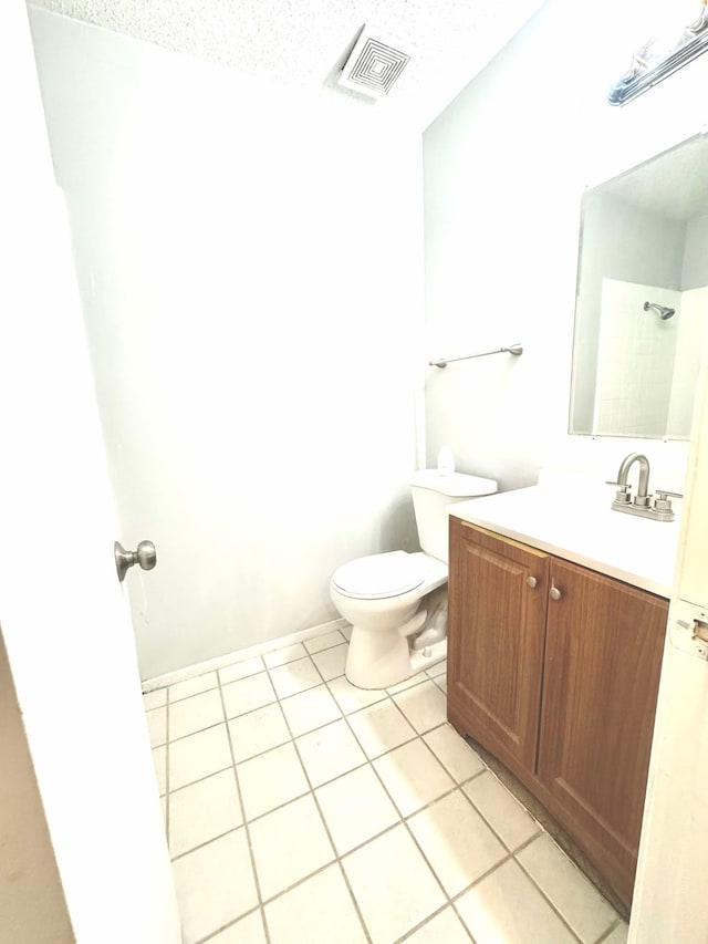 bathroom with visible vents, tile patterned flooring, vanity, and toilet