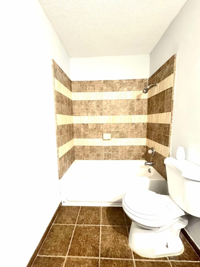 bathroom featuring shower / bathing tub combination, a textured ceiling, toilet, and tile patterned flooring