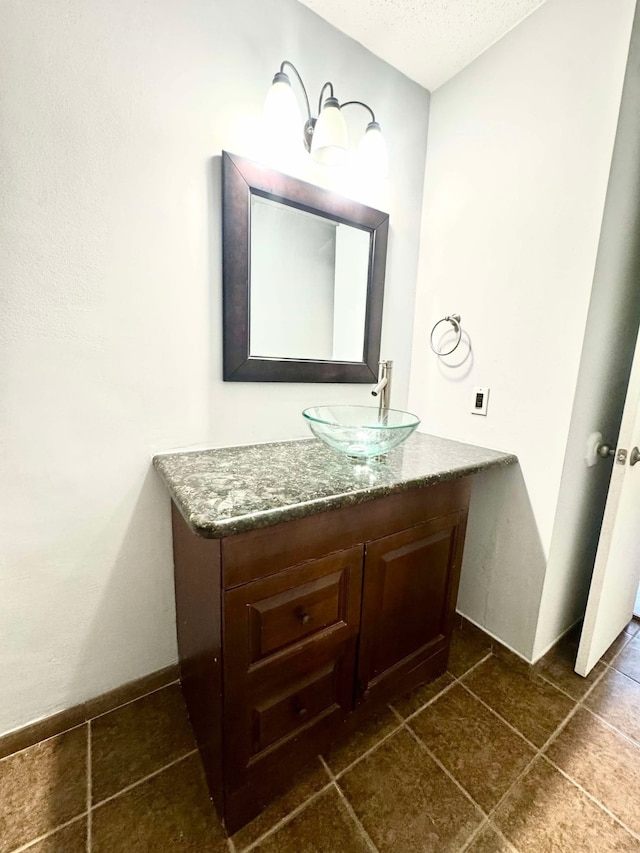bathroom featuring vanity and a textured ceiling