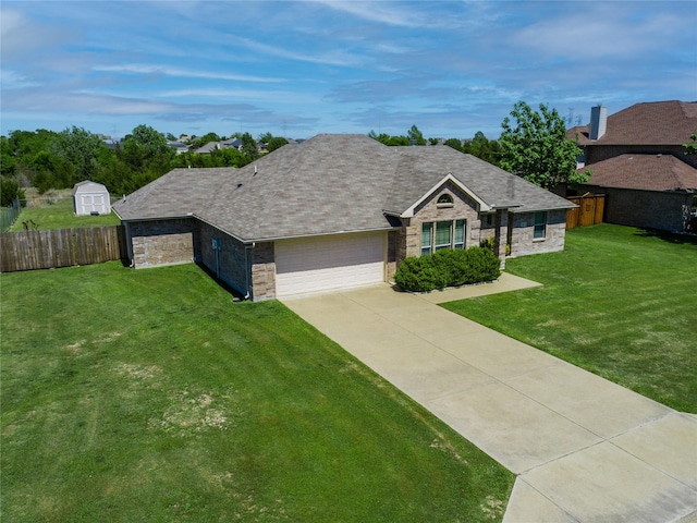 ranch-style home with driveway, a shingled roof, an attached garage, fence, and a front yard