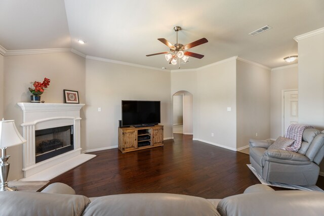 living area featuring arched walkways, visible vents, a ceiling fan, and dark wood-style floors